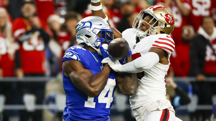 Oct 10, 2024; Seattle, Washington, USA; San Francisco 49ers safety George Odum (30) breaks up a pass thrown to Seattle Seahawks wide receiver DK Metcalf (14) during the second quarter at Lumen Field. Mandatory Credit: Joe Nicholson-Imagn Images