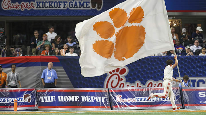 Sep 5, 2022; Atlanta, Georgia, USA; Clemson Tigers cheerleader runs a flag after a touchdown against the Georgia Tech Yellow Jackets in the second quarter at Mercedes-Benz Stadium. Mandatory Credit: Brett Davis-Imagn Images
