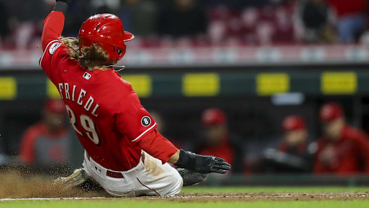 Cincinnati Reds center fielder TJ Friedl (29) slides into home plate.