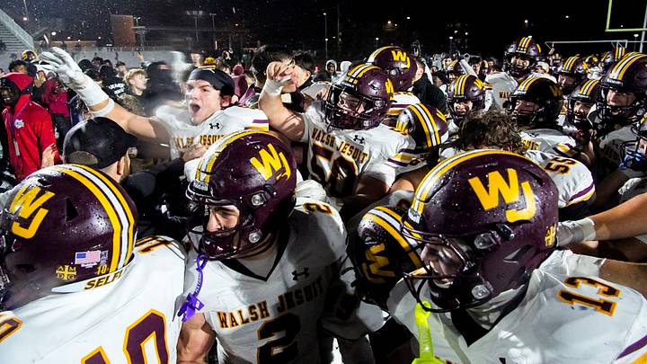 Walsh Jesuit’s coach Nick Alexander and the varsity football team celebrate their defeat over Archbishop Hoban in an OHSAA Division II regional final, Nov. 21, 2025, at Bearcats Stadium in Bedford, Ohio. Walsh Jesuit’s coach Nick Alexander and the varsity football team celebrate their defeat over Archbishop Hoban in an OHSAA Division II regional final, Nov. 21, 2025, at Bearcats Stadium in Bedford, Ohio.
