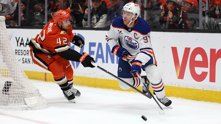 Apr 24, 2026; Anaheim, California, USA;  Edmonton Oilers center Connor McDavid (97) controls the puck against Anaheim Ducks center Tim Washe (42) during the first period of game three of the first round of the 2026 Stanley Cup Playoffs at Honda Center. Mandatory Credit: Kiyoshi Mio-Imagn Images