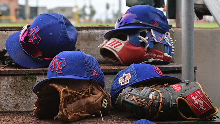 Mar 22, 2023; Scottsdale, Arizona, USA; A detail view of Texas Rangers hats and gloves during a Spring Training game against the San Francisco Giants at Scottsdale Stadium.