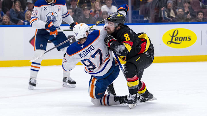 Jan 18, 2025; Vancouver, British Columbia, CAN; Edmonton Oilers forward Connor McDavid (97) battles with Vancouver Canucks forward Conor Garland (8) in the third period at Rogers Arena. Mandatory Credit: Bob Frid-Imagn Images