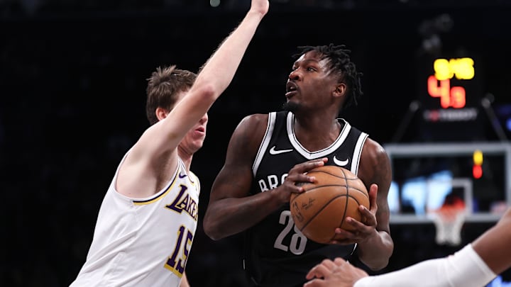 Mar 31, 2024; Brooklyn, New York, USA; Brooklyn Nets forward Dorian Finney-Smith (28) looks to the basket against Los Angeles Lakers guard Austin Reaves (15) during the first quarter at Barclays Center. Mandatory Credit: Vincent Carchietta-Imagn Images Mar 31, 2024; Brooklyn, New York, USA; Brooklyn Nets forward Dorian Finney-Smith (28) looks to the basket against Los Angeles Lakers guard Austin Reaves (15) during the first quarter at Barclays Center. Mandatory Credit: Vincent Carchietta-Imagn Images