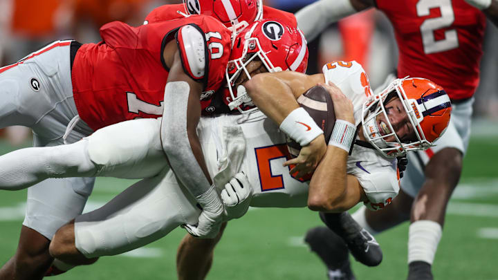 Aug 31, 2024; Atlanta, Georgia, USA; Clemson Tigers quarterback Cade Klubnik (2) is tackled by Georgia Bulldogs linebacker Damon Wilson II (10) in the first quarter at Mercedes-Benz Stadium. Aug 31, 2024; Atlanta, Georgia, USA; Clemson Tigers quarterback Cade Klubnik (2) is tackled by Georgia Bulldogs linebacker Damon Wilson II (10) in the first quarter at Mercedes-Benz Stadium.