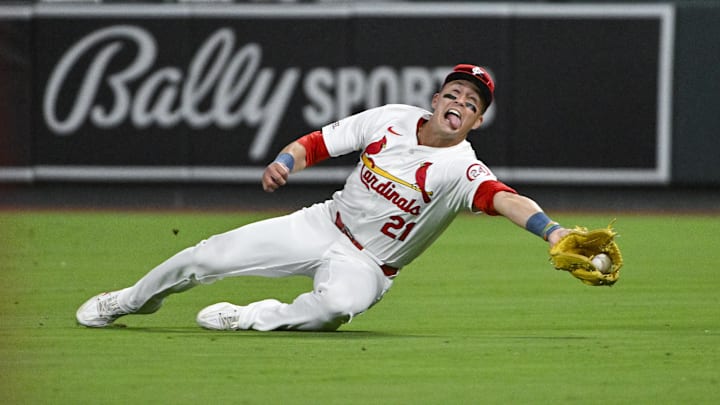 Aug 20, 2024; St. Louis, Missouri, USA;  St. Louis Cardinals right fielder Lars Nootbaar (21) dives and catches a fly ball against the Milwaukee Brewers during the seventh inning at Busch Stadium. Mandatory Credit: Jeff Curry-Imagn Images