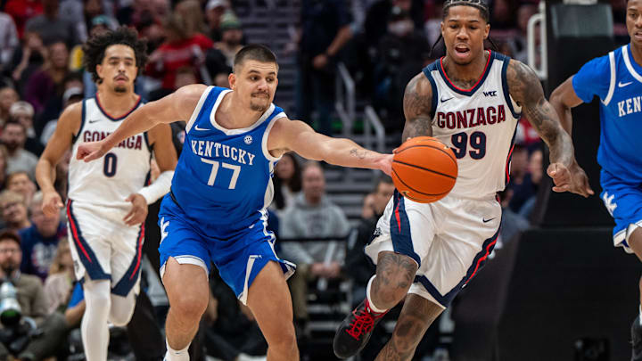 Dec 7, 2024; Seattle, Washington, USA;  Kentucky Wildcats guard Kerr Kriisa (77) knocks the ball away from Gonzaga Bulldogs guard Khalif Battle (99) during the first half at Climate Pledge Arena. Mandatory Credit: Stephen Brashear-Imagn Images