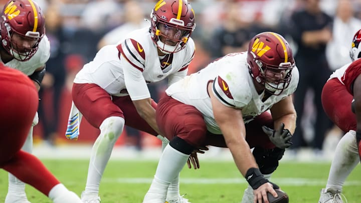 Center Tyler Biadasz snaps to Jayden Daniels during a Washington game against Arizona.