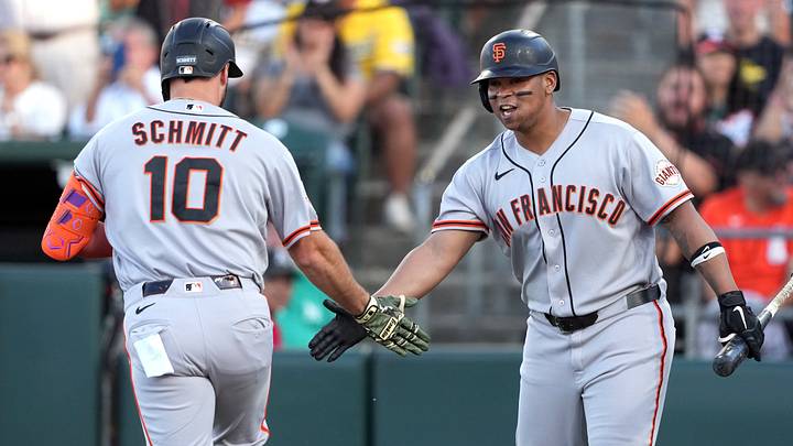 San Francisco Giants designated hitter Casey Schmitt (10) is congratulated by first baseman Rafael Devers (right) after hitting a home run. 