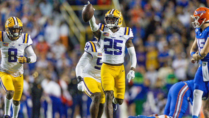 Nov 11, 2023; Baton Rouge, Louisiana, USA; LSU Tigers safety Javien Toviano (25) recovers a fumble against the Florida Gators during the first half at Tiger Stadium. Mandatory Credit: Stephen Lew-Imagn Images