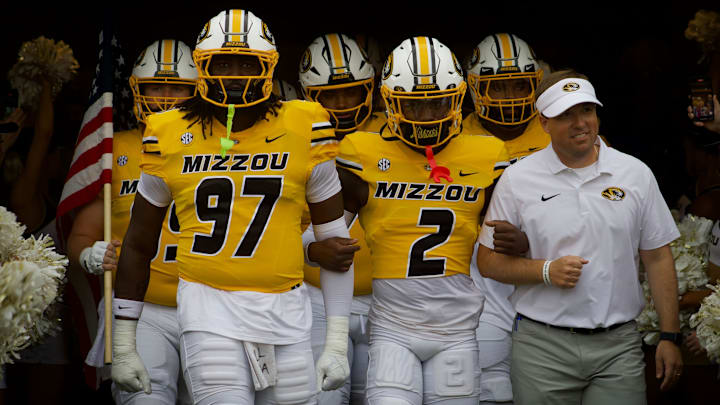 Sep 21, 2024; Missouri Tigers defensive lineman Eddie Kelly Jr. (97), cornerback Toriano Pride Jr. (2) and coach Eli Drinkwitz walk out of the tunnel at Faurot Field at Memorial Stadium.