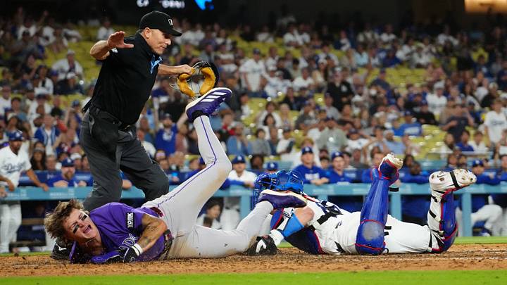 Colorado Rockies center fielder Cole Carrigg (16) slides into home plate to score against the Los Angeles Dodgers. Colorado Rockies center fielder Cole Carrigg (16) slides into home plate to score against the Los Angeles Dodgers.