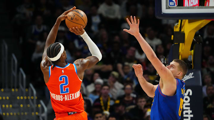 Dec 16, 2023; Denver, Colorado, USA; Oklahoma City Thunder guard Shai Gilgeous-Alexander (2) shoots the ball over Denver Nuggets center Nikola Jokic (15) in the fourth quarter at Ball Arena. Mandatory Credit: Ron Chenoy-Imagn Images