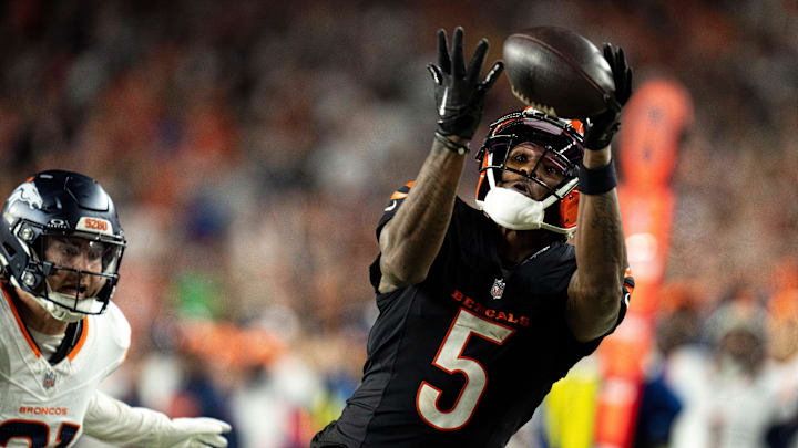 Cincinnati Bengals wide receiver Tee Higgins (5) catches a pass inside the 5-yard line as Denver Broncos cornerback Riley Moss (21) defends in overtime of the NFL game at Paycor Stadium in Cincinnati on Saturday, Dec. 28, 2024.