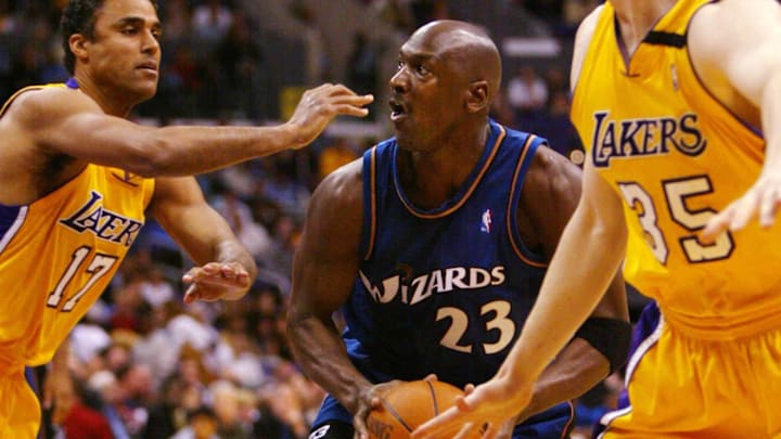 Mar 28, 2003; Los Angeles, CA, USA; FILE PHOTO; Washington Wizards guard Michael Jordan (23) drives to the basket between Los Angeles Lakers forward Rick Fox (44) and Mark Madsen (35) during the third quarter of the Wizards  108 - 94 loss to the Lakers at Staples Center. Jordan scored 23 points in the game. Mandatory Credit: Robert Hanashiro-Imagn Images