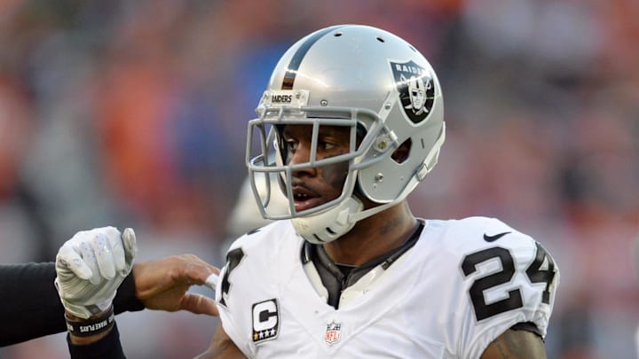Dec 13, 2015; Denver, CO, USA; Oakland Raiders free safety Charles Woodson (24) celebrates recovering a fumble in the third quarter against the Denver Broncos at Sports Authority Field at Mile High. Mandatory Credit: Ron Chenoy-Imagn Images
