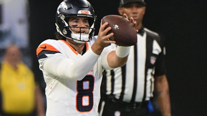 Aug 11, 2024; Indianapolis, Indiana, USA; Denver Broncos quarterback Jarrett Stidham (8) takes the snap during the first quarter against the Indianapolis Colts at Lucas Oil Stadium. Mandatory Credit: Marc Lebryk-USA TODAY Sports