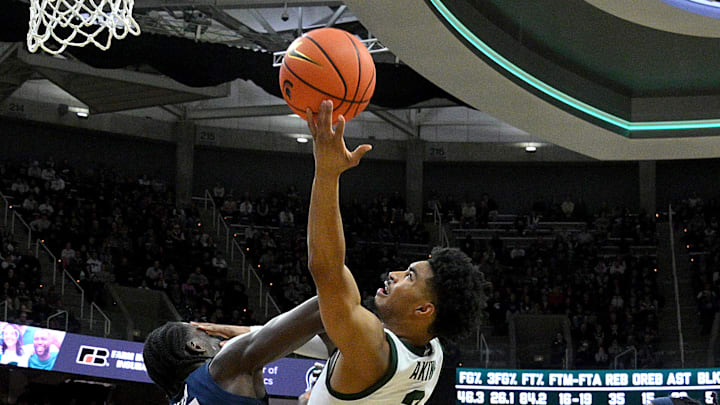 Jan 15, 2025; East Lansing, Michigan, USA;  Michigan State Spartans guard Jaden Akins (3) scores and collects a foul against the Penn State Nittany Lions during the second half at Jack Breslin Student Events Center. Mandatory Credit: Dale Young-Imagn Images