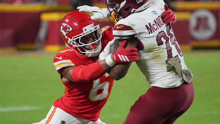 Oct 27, 2025; Kansas City, Missouri, USA; Kansas City Chiefs safety Bryan Cook (6) tackles Washington Commanders running back Jeremy McNichols (26) during the third quarter of the game at GEHA Field at Arrowhead Stadium. Mandatory Credit: Denny Medley-Imagn Images