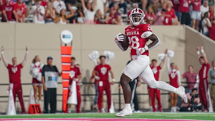 Sep 12, 2025; Bloomington, Indiana, USA; Indiana Hoosiers running back Khobie Martin (28) runs for a touchdown during the second half against the Indiana State Sycamores at Memorial Stadium. Mandatory Credit: Robert Goddin-Imagn Images