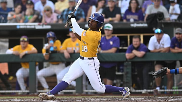 Jun 26, 2023; Omaha, NE, USA;  LSU Tigers first baseman Tre' Morgan (18) hits a single RBI against the Florida Gators in the second inning at Charles Schwab Field Omaha.