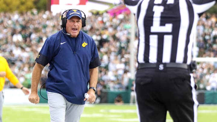 Sep 6, 2025; Athens, Ohio, USA; West Virginia Mountaineers head coach Rich Rodriguez calls a timeout during the second quarter against the Ohio Bobcats at Peden Stadium. Mandatory Credit: Ben Queen-Imagn Images