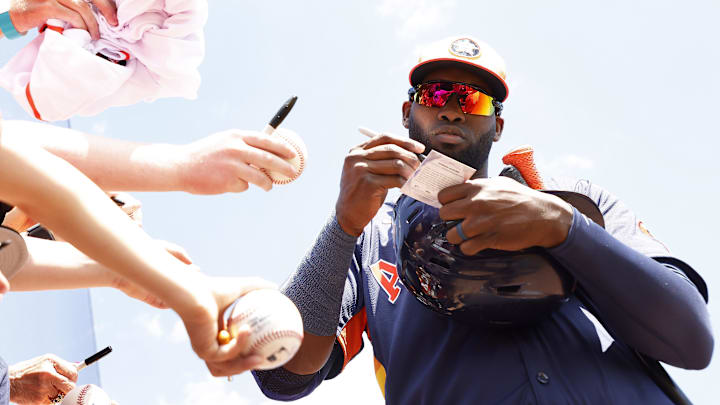 Houston Astros designated hitter Yordan Alvarez (44) signs autographs.