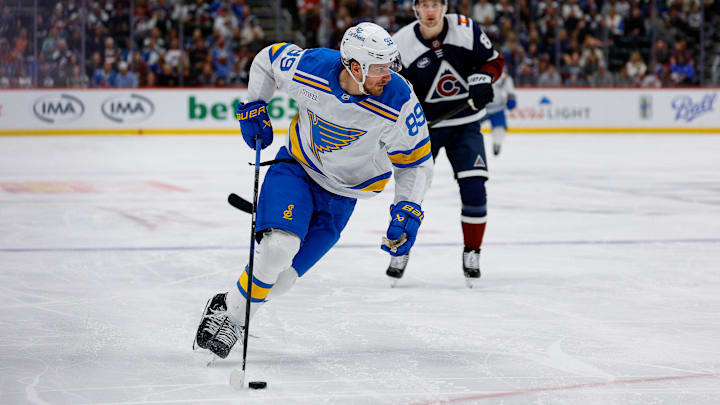 Apr 5, 2026; Denver, Colorado, USA; St. Louis Blues left wing Pavel Buchnevich (89) controls the puck in the third period against the Colorado Avalanche at Ball Arena. Mandatory Credit: Isaiah J. Downing-Imagn Images
