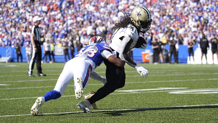 Sep 28, 2025; Orchard Park, New York, USA;  New Orleans Saints running back Alvin Kamara (41) is tackled by Buffalo Bills cornerback Dorian Strong (43) during the third quarter bat Highmark Stadium.