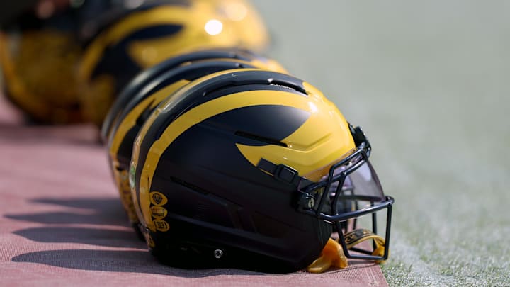 Sep 6, 2025; Norman, Oklahoma, USA; Michigan Wolverine helmets sit on the field near the sideline prior to a game against the Oklahoma Sooners at Gaylord Family-Oklahoma Memorial Stadium. Mandatory Credit: Kevin Jairaj-Imagn Images