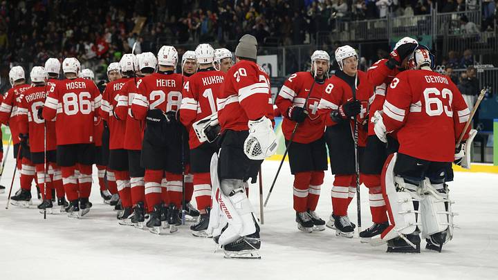Feb 17, 2026; Milan, Italy;  Switzerland players celebrate after the match against Italy during a men's ice hockey qualification playoff game during the Milano Cortina 2026 Olympic Winter Games at Milano Santagiulia Ice Hockey Arena. Mandatory Credit: Geoff Burke-Imagn Images