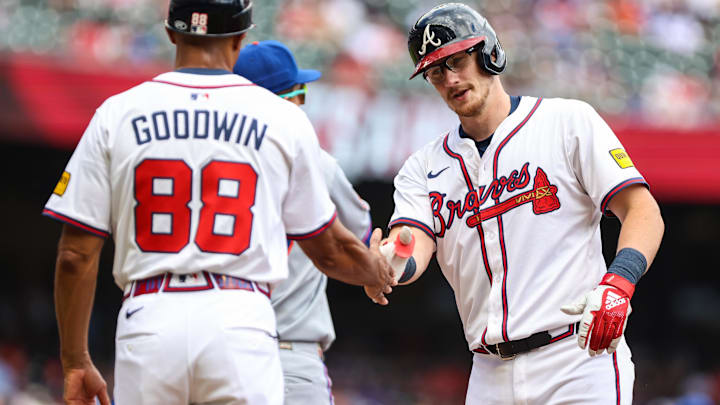 Atlanta Braves catcher Sean Murphy (12) celebrates at first base with Atlanta Braves first base coach Tom Goodwin (88) after a hit against the New York Mets during the second inning at Truist Park. Mandatory Credit: Jordan Godfree-Imagn Images