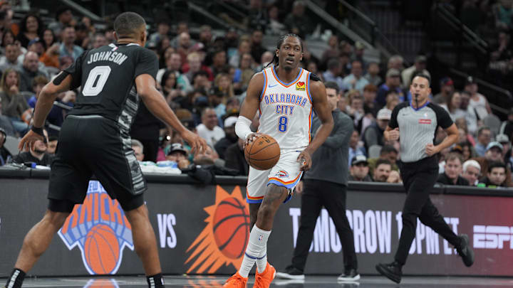 Nov 19, 2024; San Antonio, Texas, USA;  Oklahoma City Thunder forward Jalen Williams (8) dribbles in front of San Antonio Spurs forward Keldon Johnson (0) in the second half at Frost Bank Center. Mandatory Credit: Daniel Dunn-Imagn Images