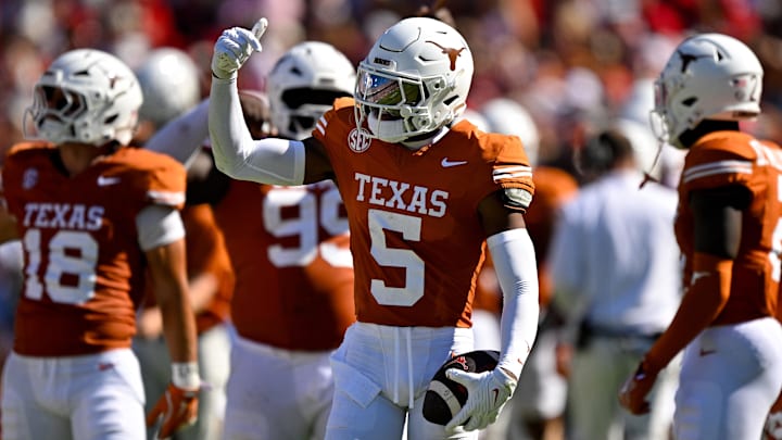 Texas Longhorns defensive back Malik Muhammad celebrates after he intercepts a pass during the first half at the Cotton Bowl.