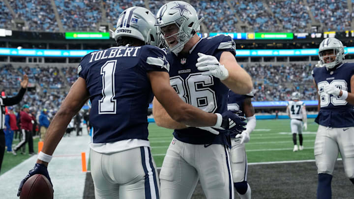 Dallas Cowboys WR Jalen Tolbert celebrates with TE Luke Schoonmaker after scoring a touchdown against the Panthers.