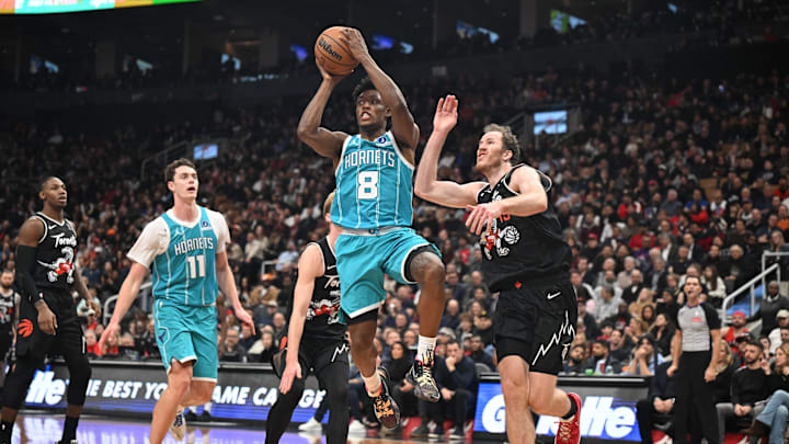 Nov 17, 2025; Toronto, Ontario, CAN;  Charlotte Hornets guard Collin Sexton (8) controls the ball as Toronto Raptors center Jakob Poeltl (19) defends in the second half at Scotiabank Arena. Mandatory Credit: Dan Hamilton-Imagn Images