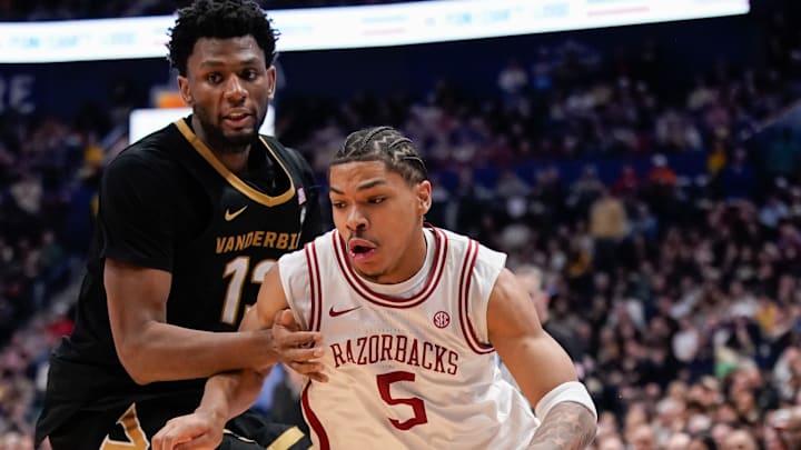 Arkansas guard Darius Acuff Jr. (5) gets past Vanderbilt forward Jalen Washington (13) during the second half of the SEC tournament championship game at Bridgestone Arena in Nashville, Tenn., Sunday, March 15, 2026.