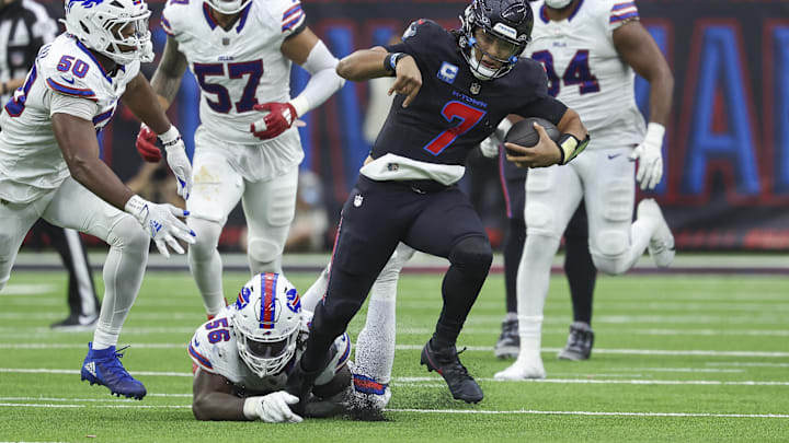 Oct 6, 2024; Houston, Texas, USA; Houston Texans quarterback C.J. Stroud (7) runs with the ball as Buffalo Bills defensive end Javon Solomon (56) attempts to make a tackle during the game at NRG Stadium. Oct 6, 2024; Houston, Texas, USA; Houston Texans quarterback C.J. Stroud (7) runs with the ball as Buffalo Bills defensive end Javon Solomon (56) attempts to make a tackle during the game at NRG Stadium.