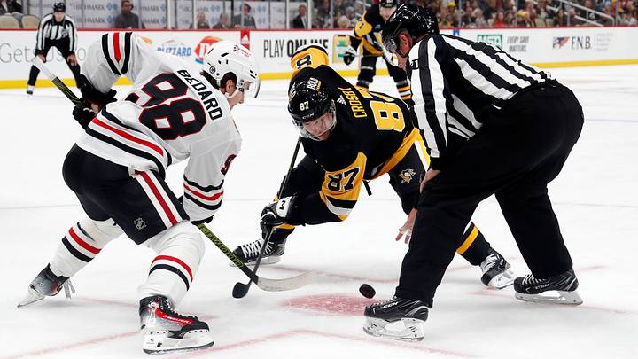 Chicago Blackhawks' Connor Bedard (98) and Pittsburgh Penguins' Sidney Crosby (87) take a face-off during the third period at the PPG Paints Arena. Chicago won 4-2.  Mandatory Credit: Charles LeClaire-USA TODAY Sports