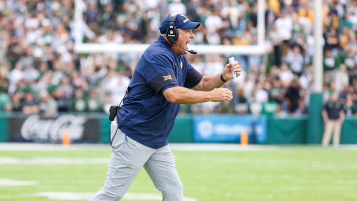 Sep 6, 2025; Athens, Ohio, USA; West Virginia Mountaineers head coach Rich Rodriguez calls a timeout during the second quarter against the Ohio Bobcats at Peden Stadium. Mandatory Credit: Ben Queen-Imagn Images
