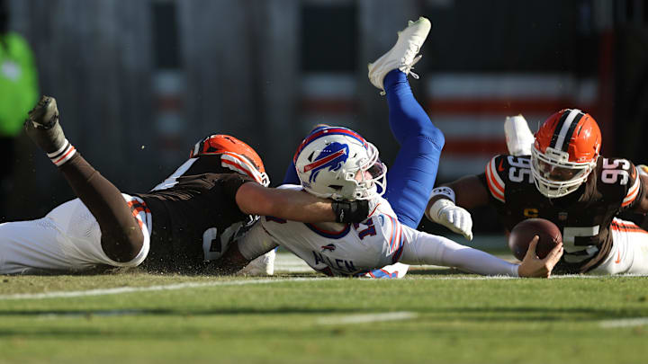 Dec 21, 2025; Cleveland, Ohio, USA;  Buffalo Bills quarterback Josh Allen (17) is sacked by Cleveland Browns defensive tackle Mason Graham (94) and defensive end Myles Garrett (95) during the first half at Huntington Bank Field.