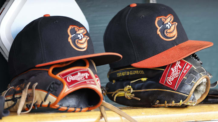 Baltimore Orioles hats and glove sits in dugout Baltimore Orioles hats and glove sits in dugout
