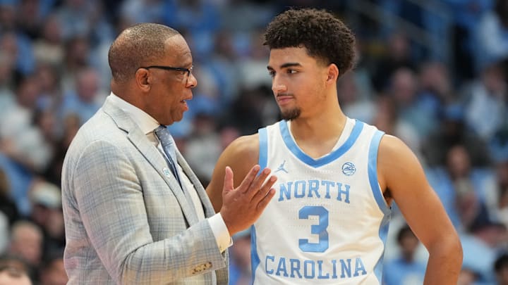Dec 7, 2025; Chapel Hill, North Carolina, USA;  North Carolina Tar Heels head coach Hubert Davis talks with guard Derek Dixon (3) in the second half at Dean E. Smith Center. Mandatory Credit: Bob Donnan-Imagn Images