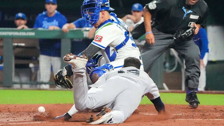 Jun 12, 2025; Kansas City, Missouri, USA; Kansas City Royals catcher Freddy Fermin (34) misses the tag as New York Yankees second baseman Pablo Reyes (19) scores in the eighth inning at Kauffman Stadium. Mandatory Credit: Denny Medley-Imagn Images