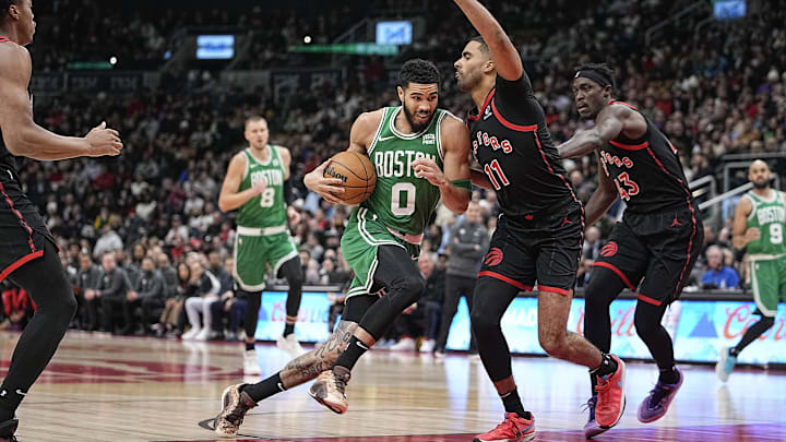 Jan 15, 2024; Toronto, Ontario, CAN; Boston Celtics forward Jayson Tatum (0) drives to the basket against Toronto Raptors forward Jontay Porter (11) during the first half at Scotiabank Arena. Mandatory Credit: John E. Sokolowski-Imagn Images