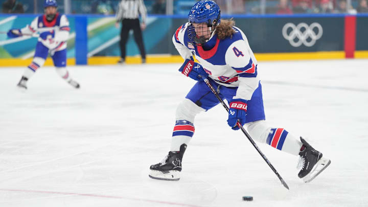 Feb 10, 2026; Milan, Italy; Caroline Harvey (4) of the United States shoots and scores a goal against Canada in women's ice hockey group A play during the Milano Cortina 2026 Olympic Winter Games at Milano Santagiulia Ice Hockey Arena. 