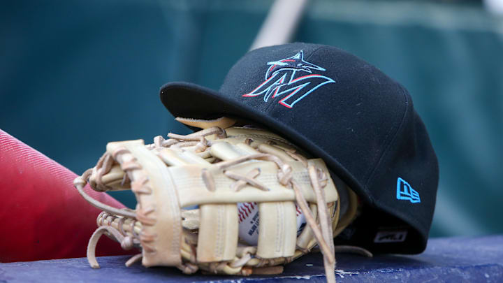 Apr 24, 2024; Atlanta, Georgia, USA; A detailed view of a Miami Marlins hat and glove in the dugout before a game against the Atlanta Braves at Truist Park. Mandatory Credit: Brett Davis-Imagn Images
