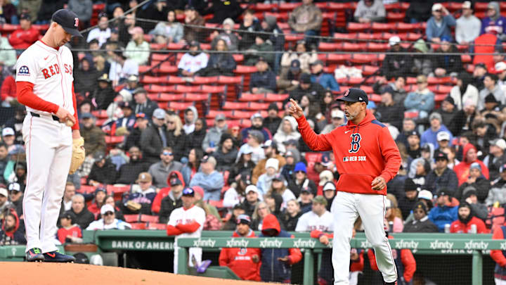 Apr 10, 2025; Boston, Massachusetts, USA; Boston Red Sox manager Alex Cora (13) signals to the bullpen as he heads out to relive starting pitcher Walker Buehler (0) of pitching duties during the seventh inning against the Toronto Blue Jays at Fenway Park. Mandatory Credit: Eric Canha-Imagn Images