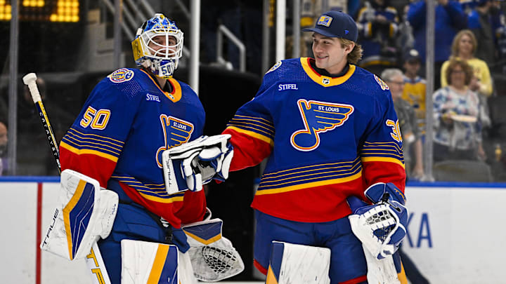 Mar 13, 2024; St. Louis, Missouri, USA;  St. Louis Blues goaltender Jordan Binnington (50) celebrates with goaltender Joel Hofer (30) after the Blues defeated the Los Angeles Kings at Enterprise Center. Mandatory Credit: Jeff Curry-Imagn Images