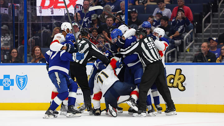 Oct 2, 2025; Tampa, Florida, USA; Florida Panthers center Luke Kunin (71) and Tampa Bay Lightning center Jack Finley (62) lock up in the third period at Benchmark International Arena. Mandatory Credit: Nathan Ray Seebeck-Imagn Images